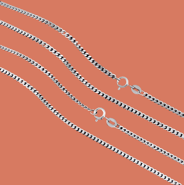Multiple 925 sterling silver Figaro chain necklaces with a diamond-cut finish laid out on a dark surface.