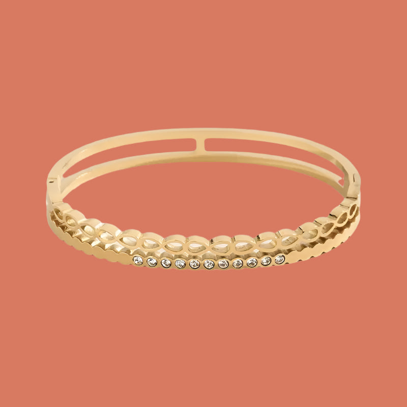 A gold-plated stainless steel bangle bracelet with multicolored zircon stones set in a polished finish.