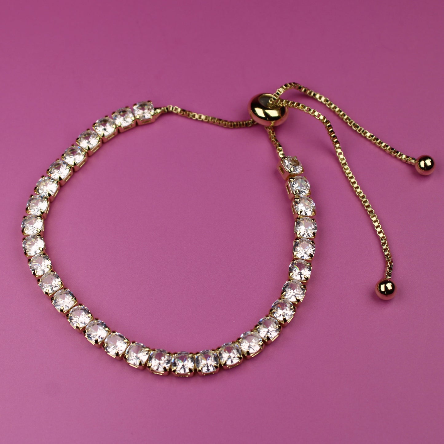 Bracelet with clear stones on a pink background