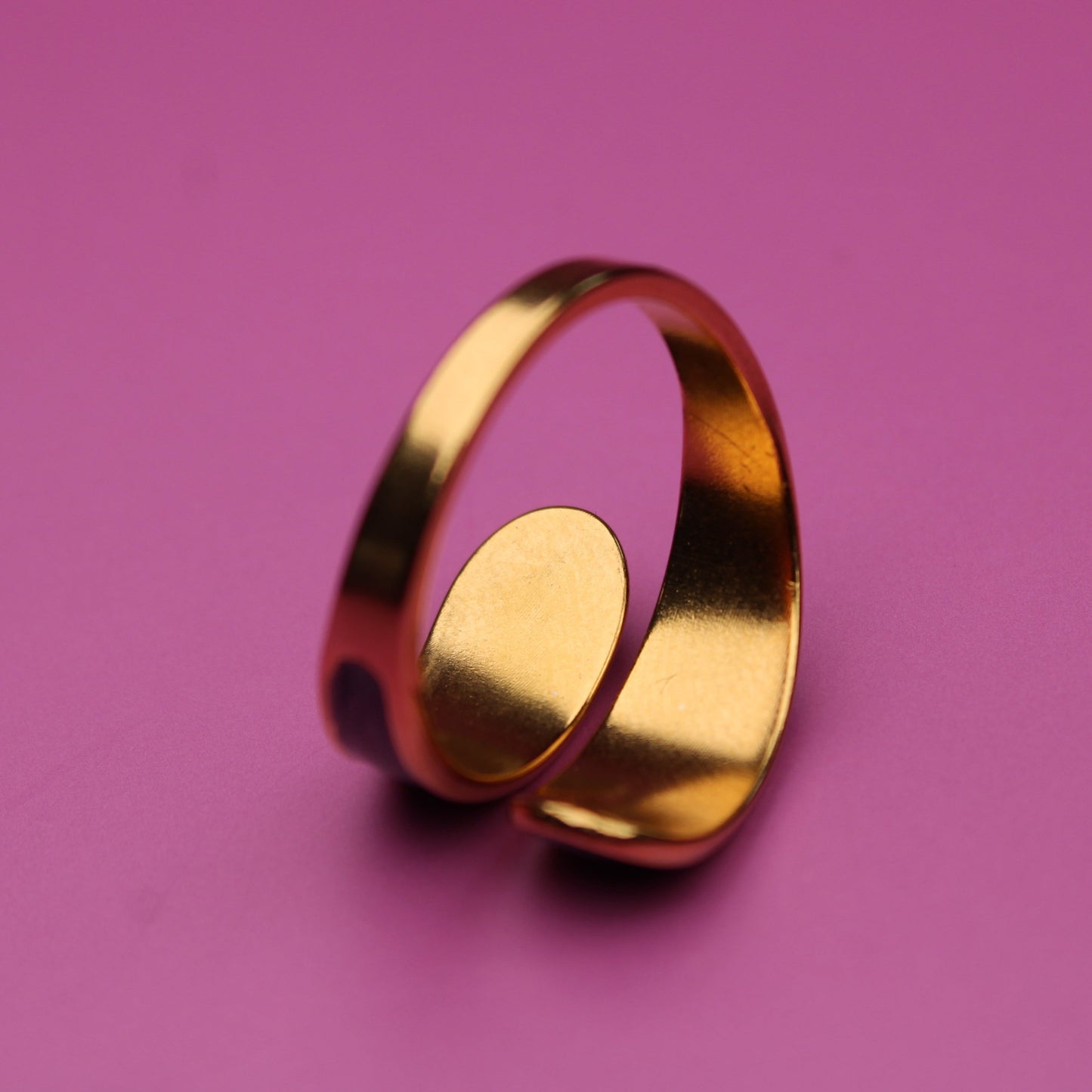 Gold ring on a pink background