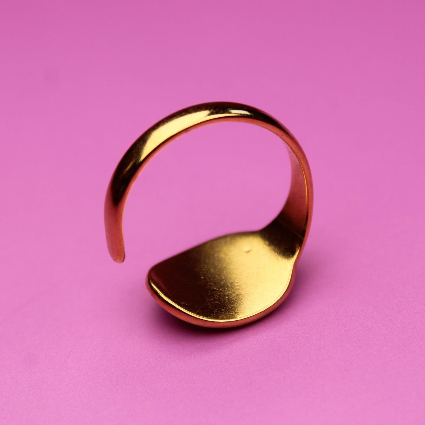 Gold ring on a pink background