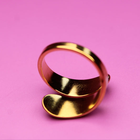 Gold ring on a pink background