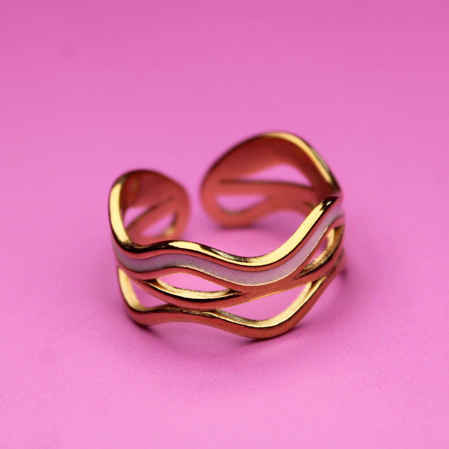 Gold ring on a pink background