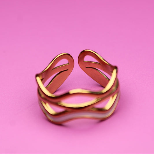 Gold ring on a pink background