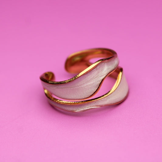 Gold and silver ring on a pink background