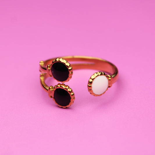 Ring with multicolored gemstones on a pink background