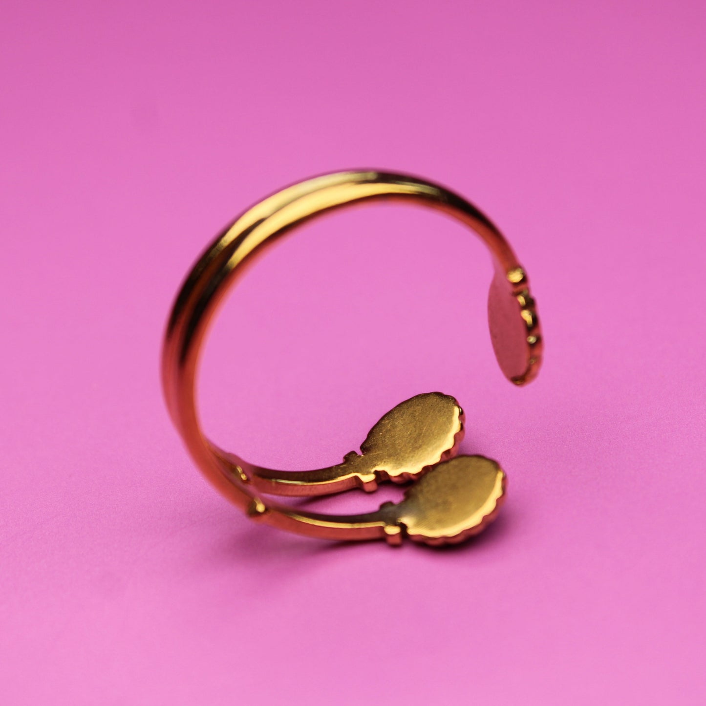 Gold ring on a pink background