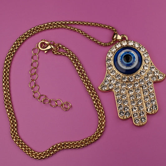 Gold necklace with a Hamsa hand pendant featuring an eye on a pink background