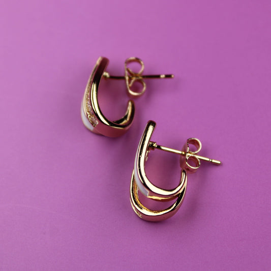 Gold hoop earrings on a purple background