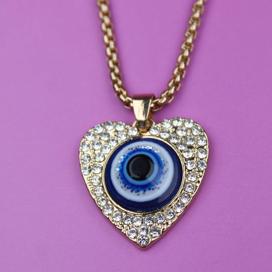 Heart-shaped necklace with an evil eye design on a purple background