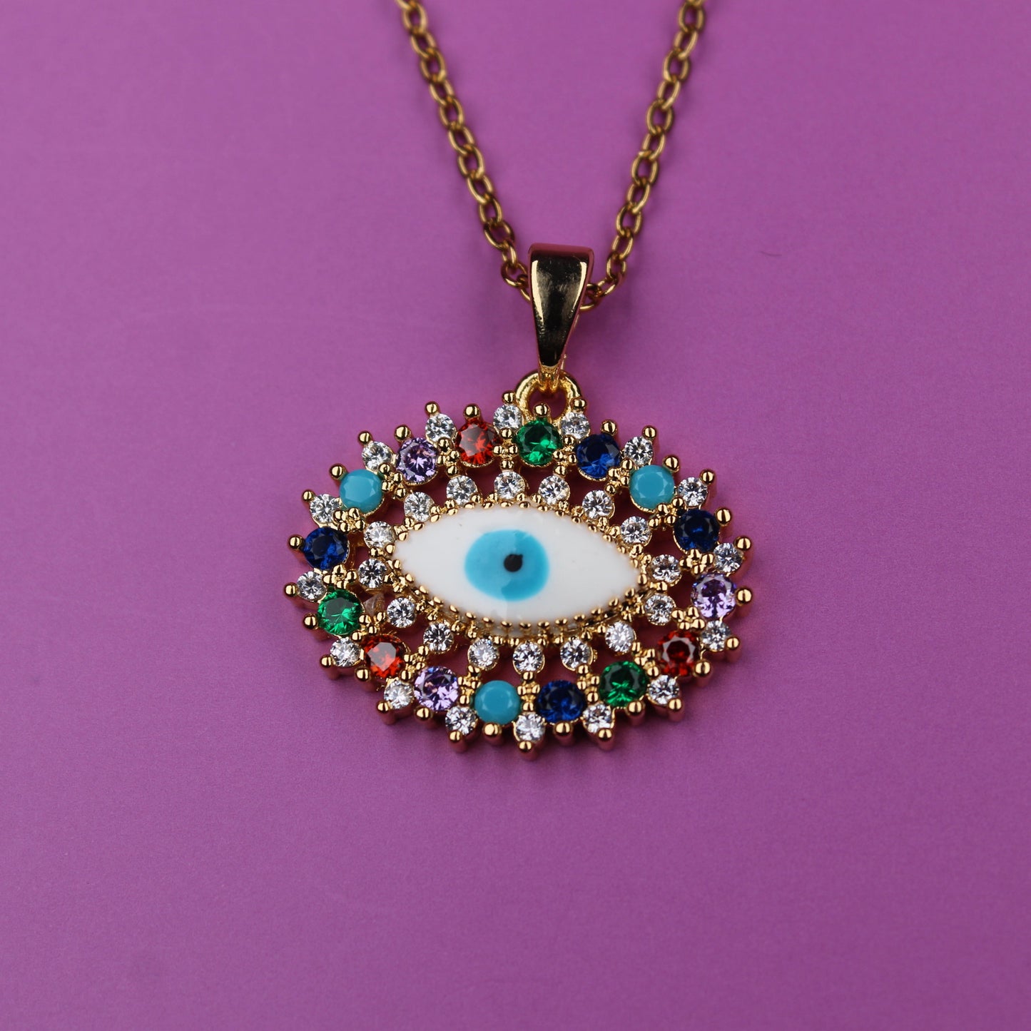 Colorful evil eye pendant necklace on a purple background