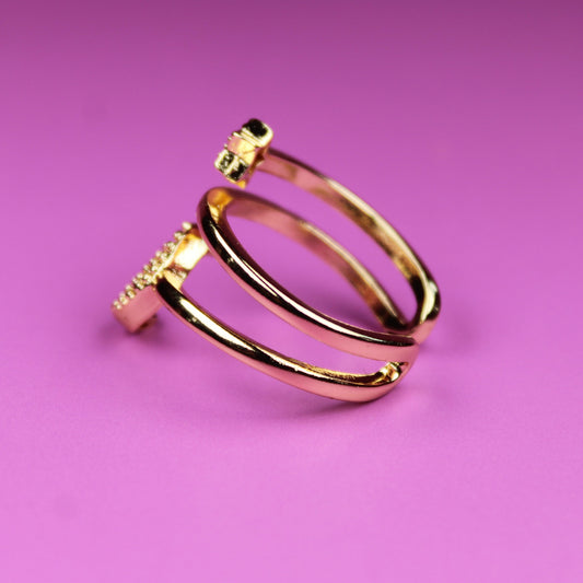 Gold ring on a pink background