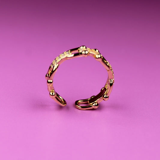 Gold ring on a pink background