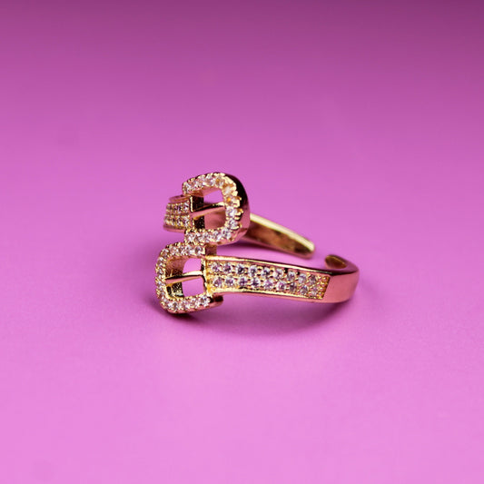 Rose gold ring with gemstones on a pink background