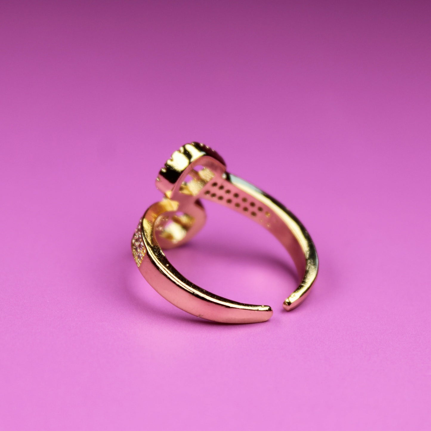 Gold ring on a pink background