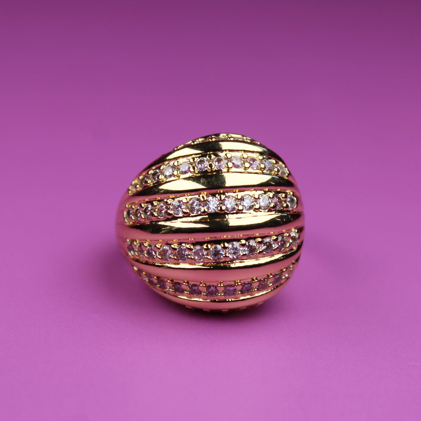 Gold and pink decorative ball on a pink background