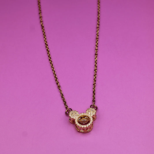 Necklace with a heart-shaped pendant on a pink background