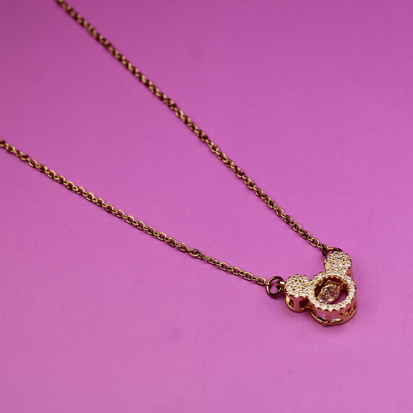 Necklace with a heart-shaped pendant on a pink background
