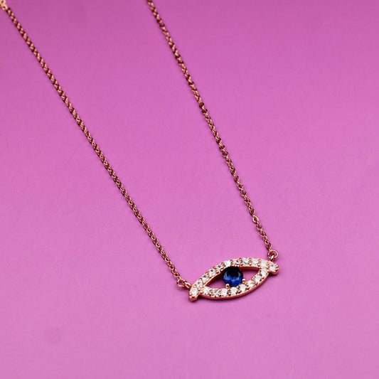 Necklace with a eye-shaped pendant on a pink background