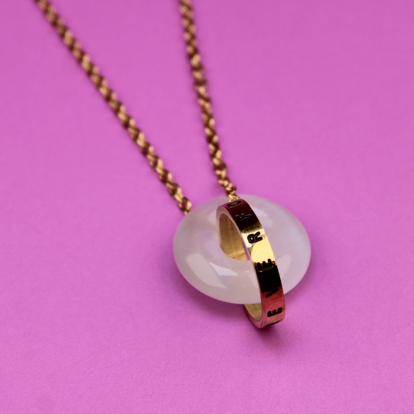 Necklace with a pendant on a pink background