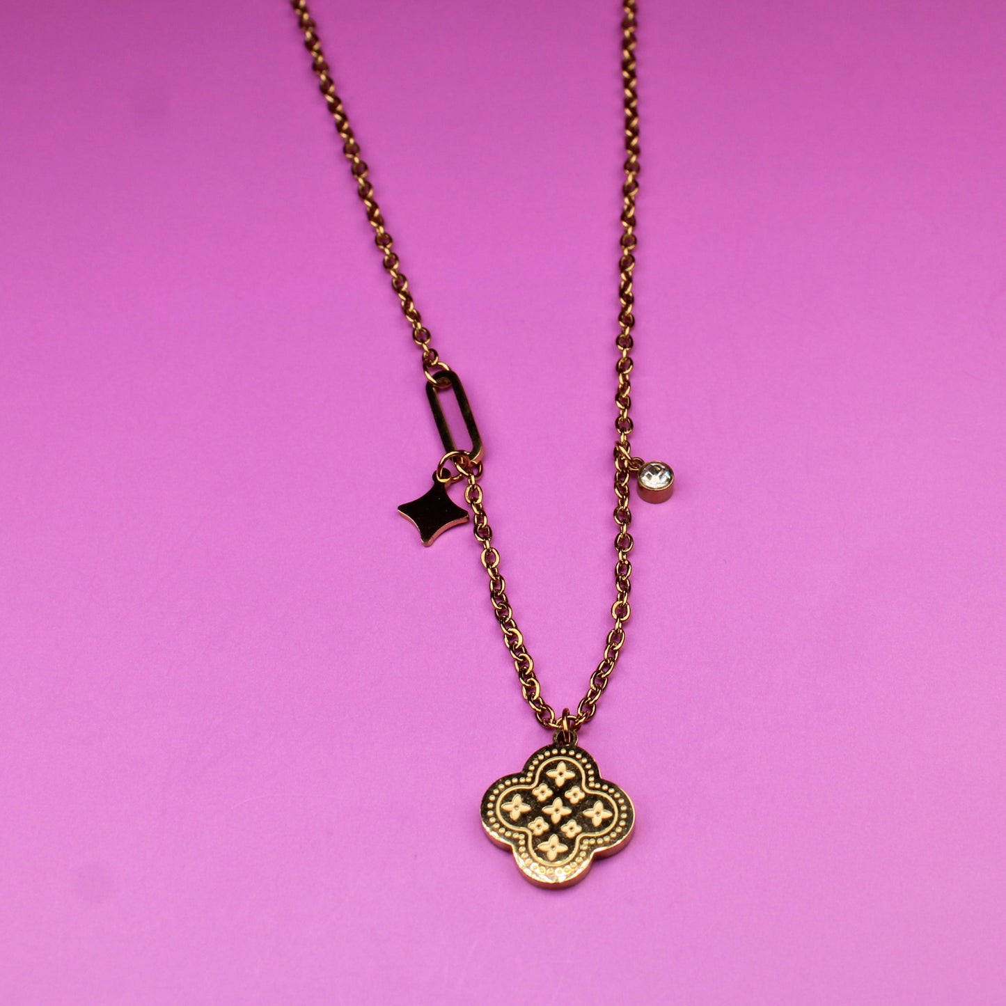 Necklace with a pendant on a pink background