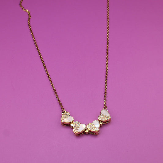 Necklace with heart-shaped pendants on a purple background