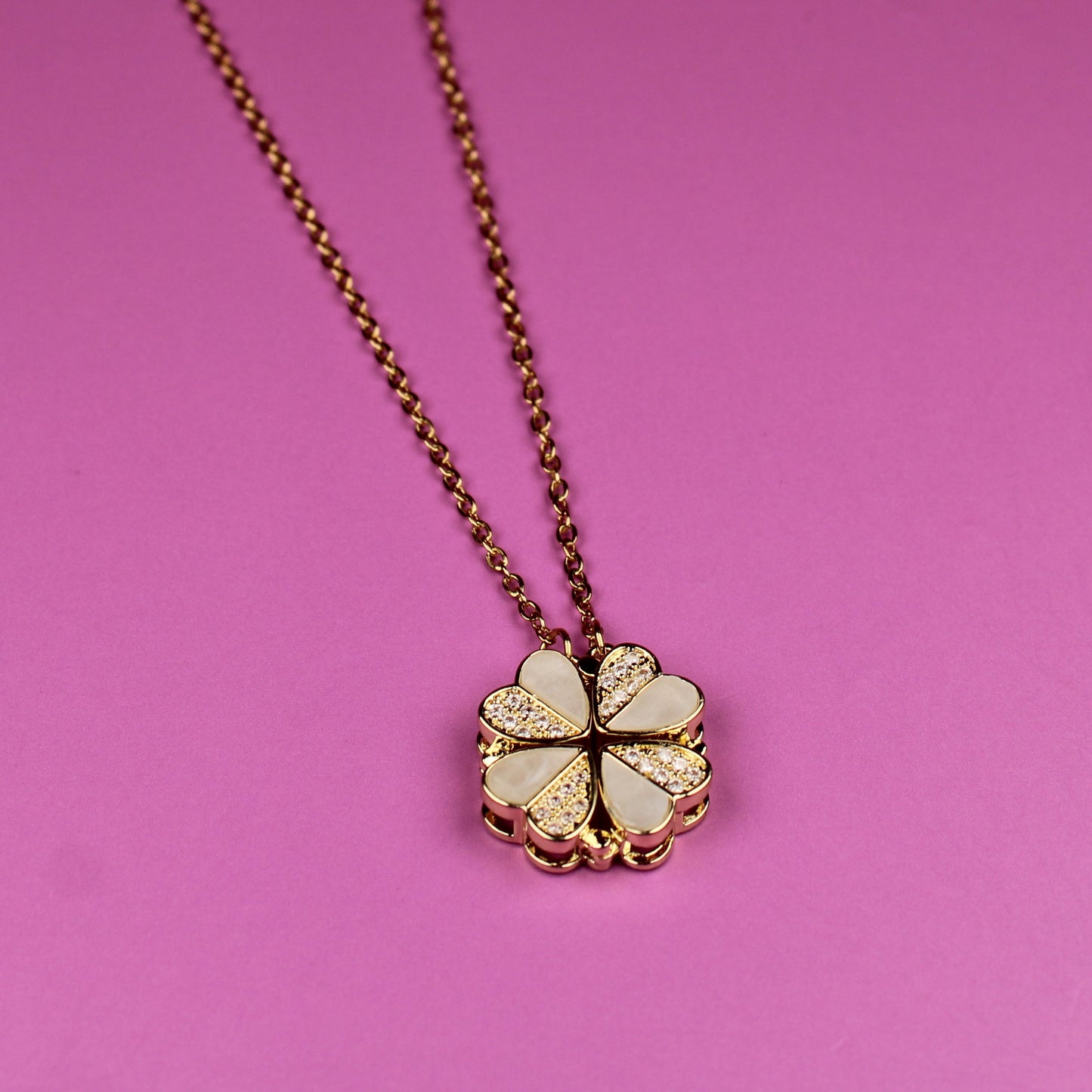 Necklace with a floral pendant on a pink background