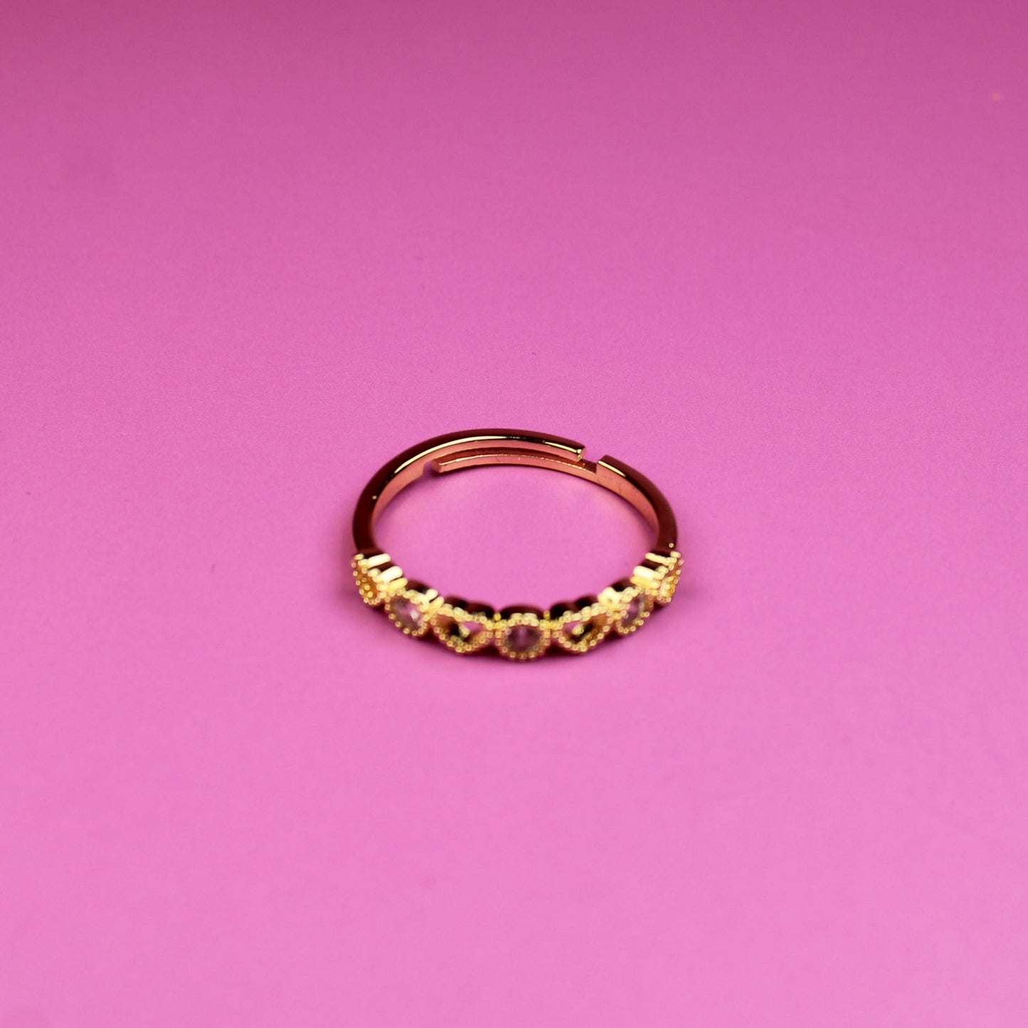 Gold ring on a pink background