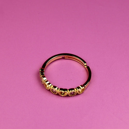 Gold ring on a pink background