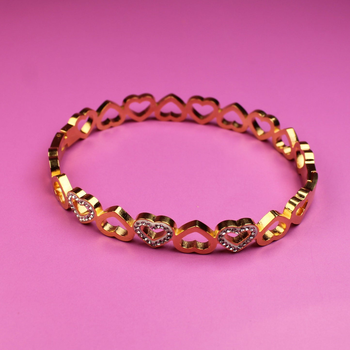 Bracelet with heart-shaped links on a pink background