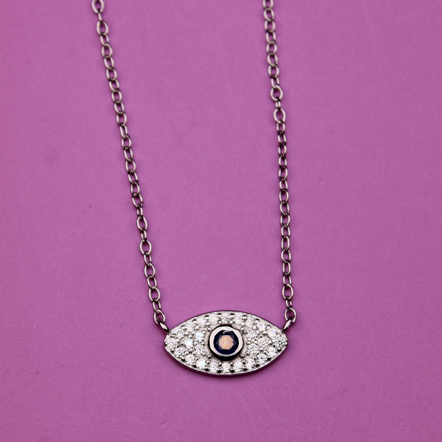 Necklace with an eye-shaped pendant on a purple background
