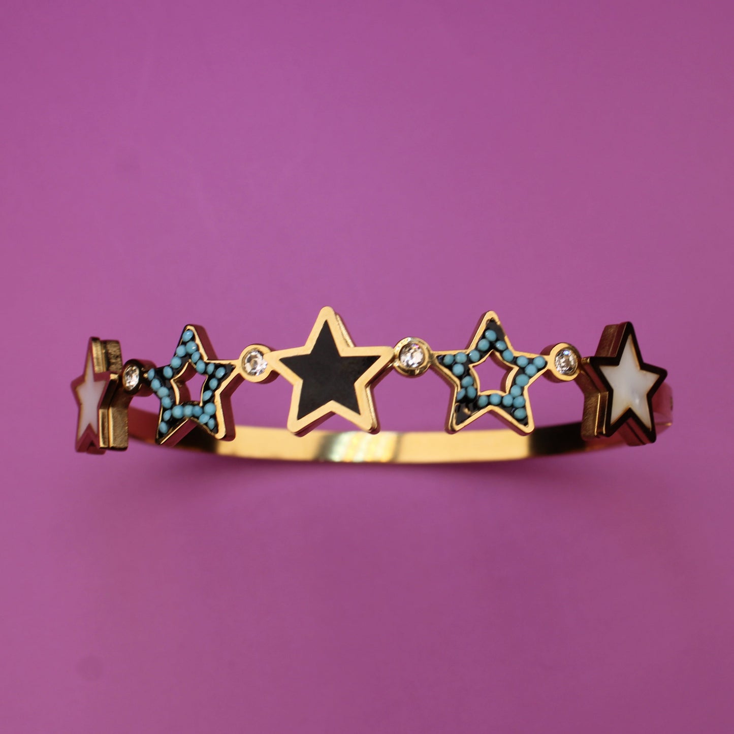 Bracelet with star-shaped charms on a purple background