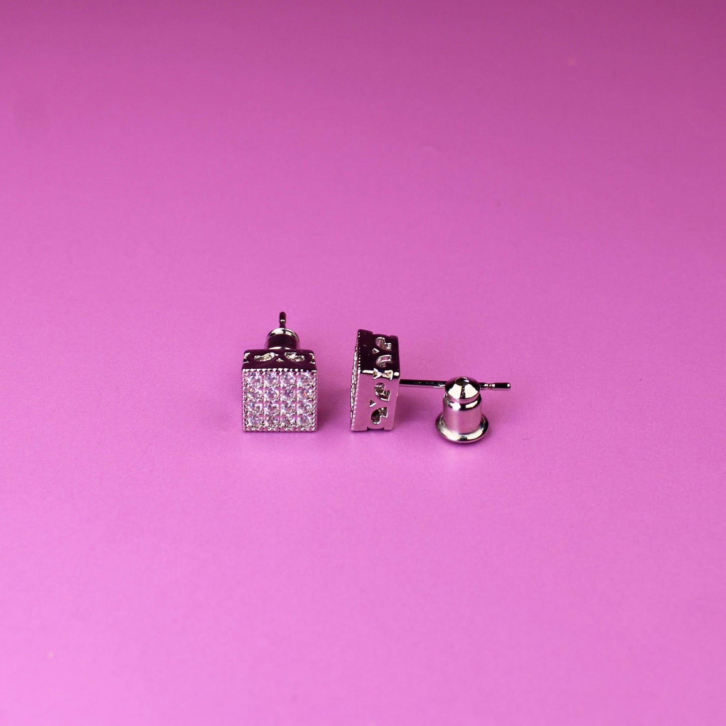 Pair of cufflinks on a pink background