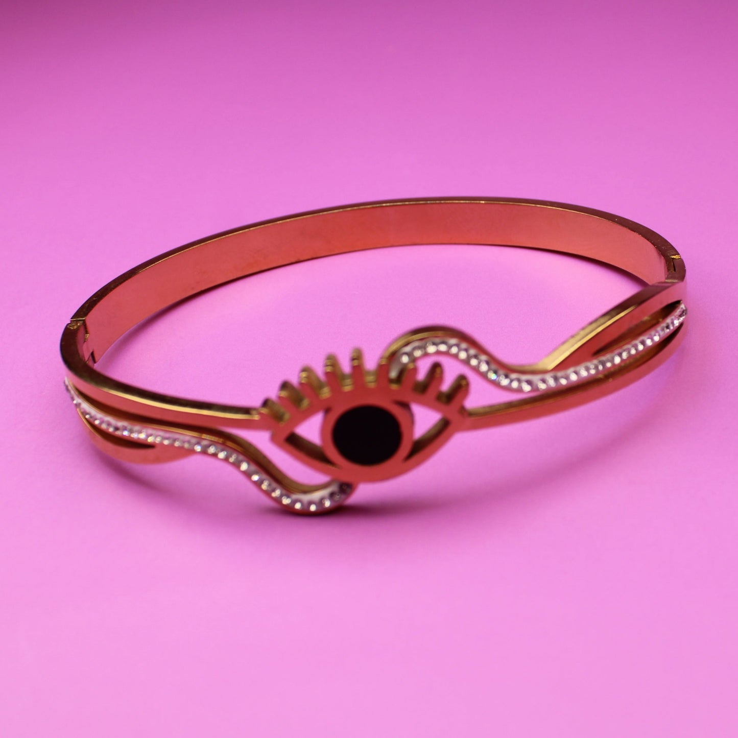 Bracelet with an eye design on a pink background