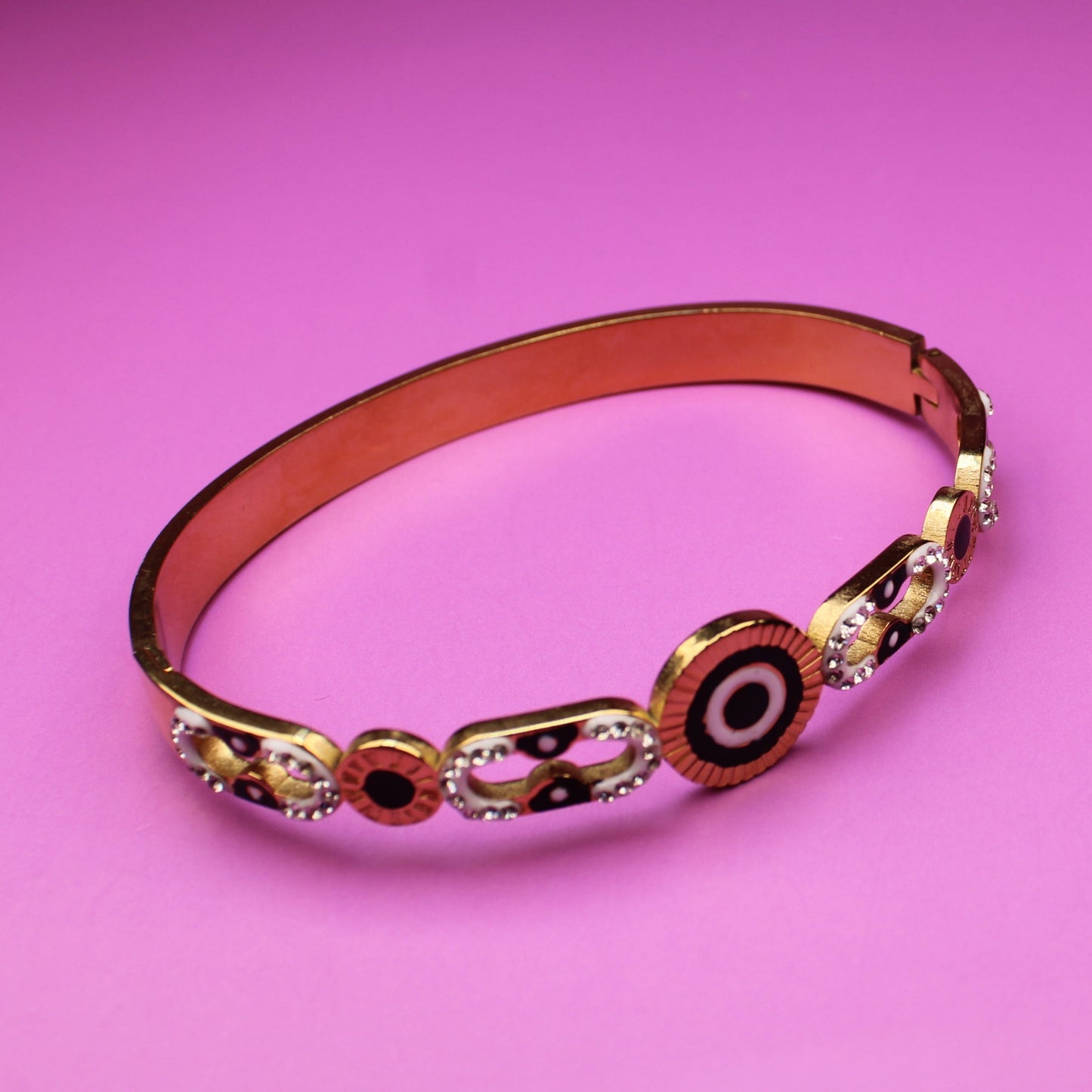 Decorative bracelet with circular patterns on a pink background