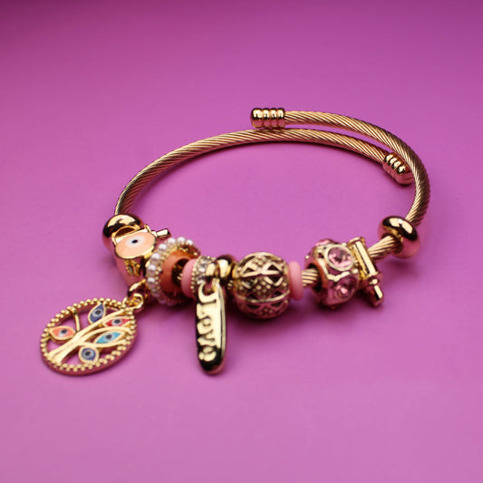 Gold bracelet with charms on a purple background