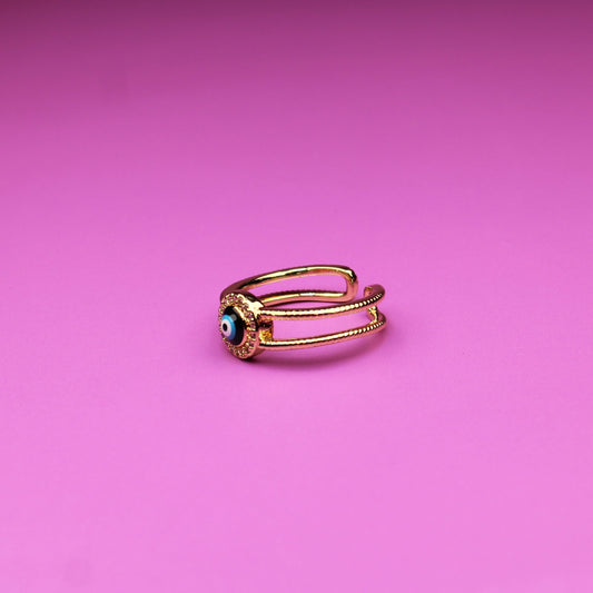 Gold ring on a pink background