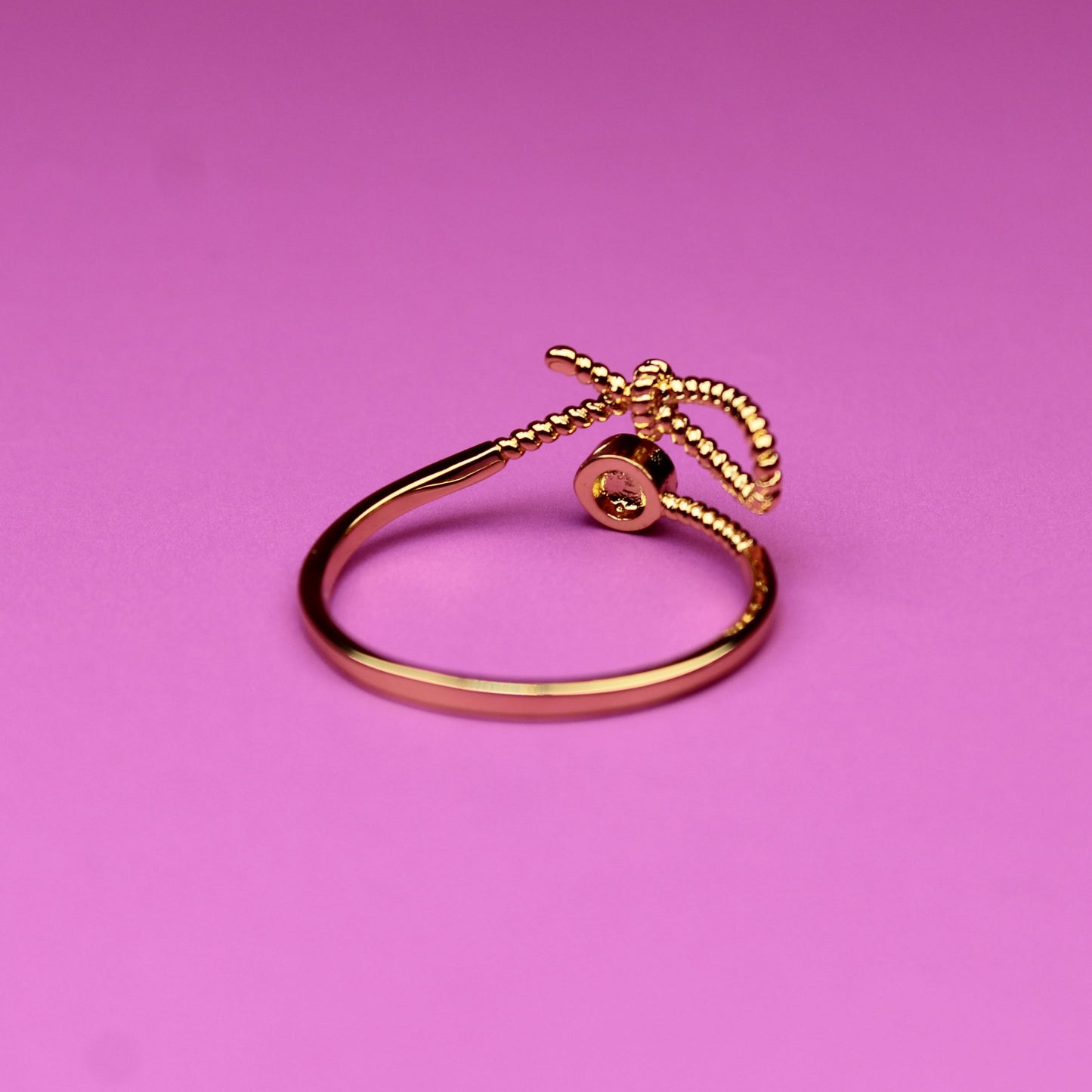 Gold ring on a pink background