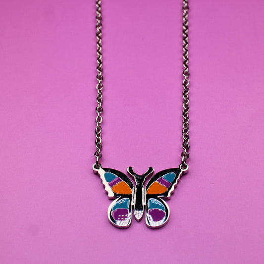 Butterfly necklace on a pink background