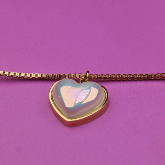 Bracelet with a heart-shaped charm on a purple background