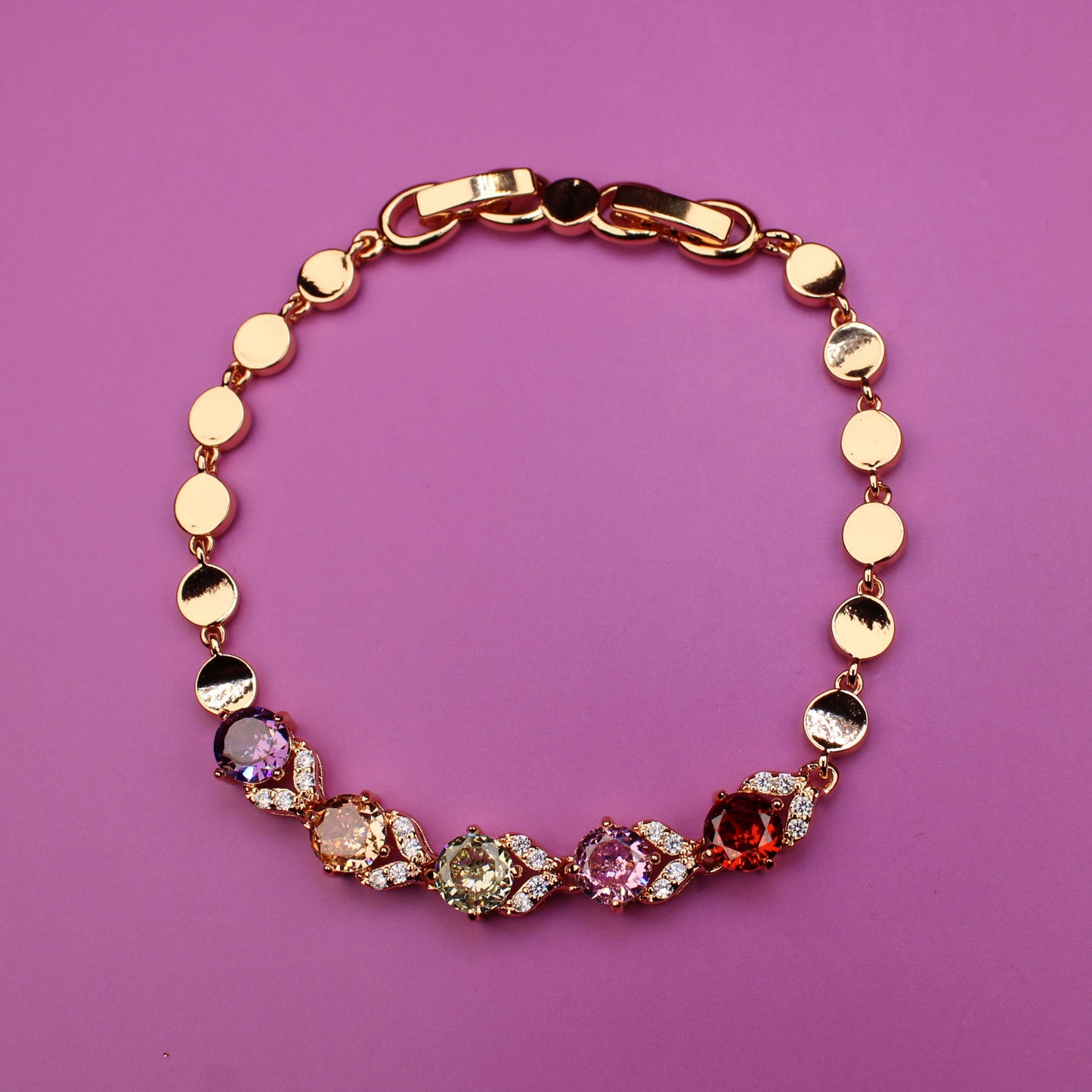 Bracelet with colorful beads on a pink background