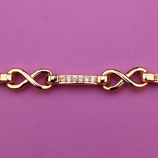 Gold bracelet with diamond accents on a purple background