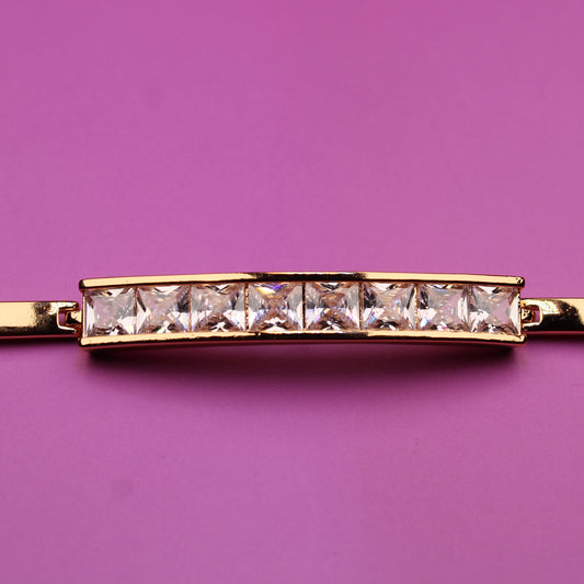Gold bracelet with diamonds on a purple background