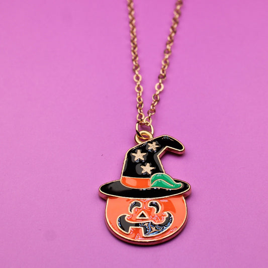 Halloween-themed necklace with a pumpkin pendant on a pink background