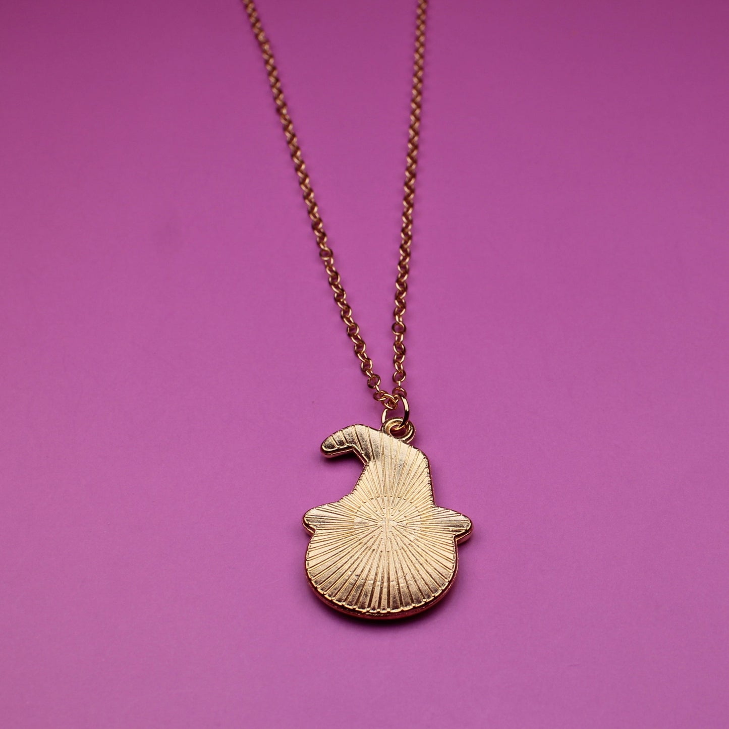 Necklace with a shell pendant on a purple background