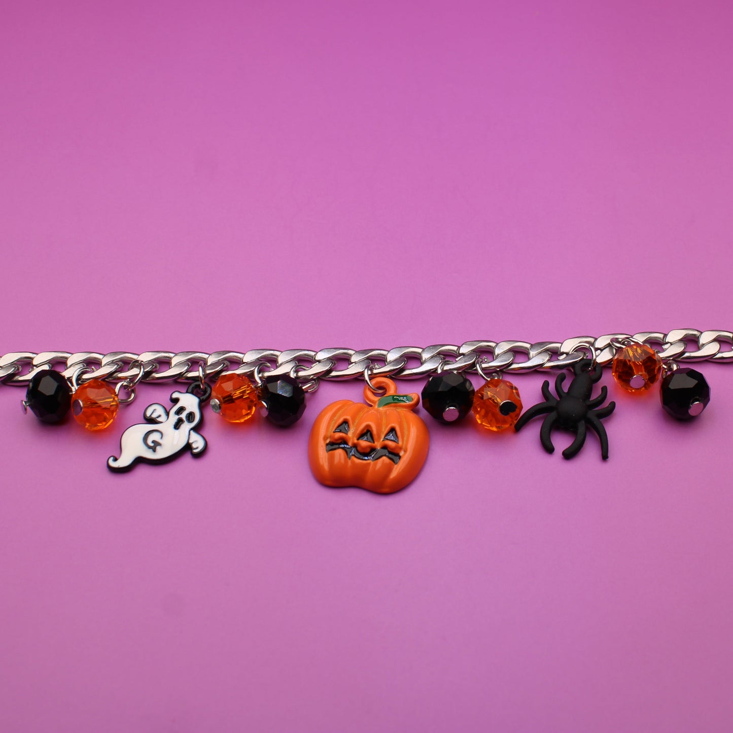 Bracelet with Halloween-themed charms on a purple background