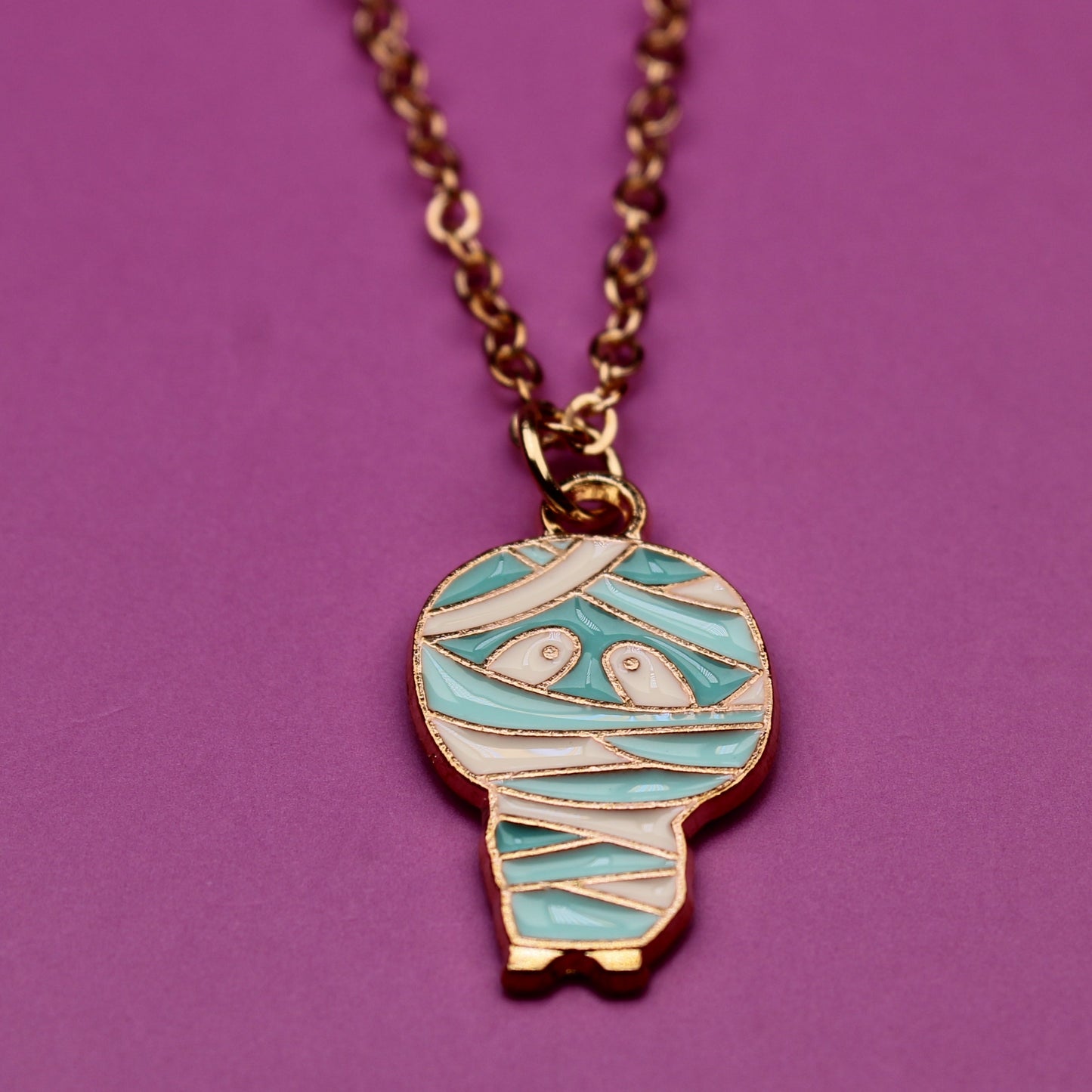 Necklace with a mummy-shaped pendant on a purple background