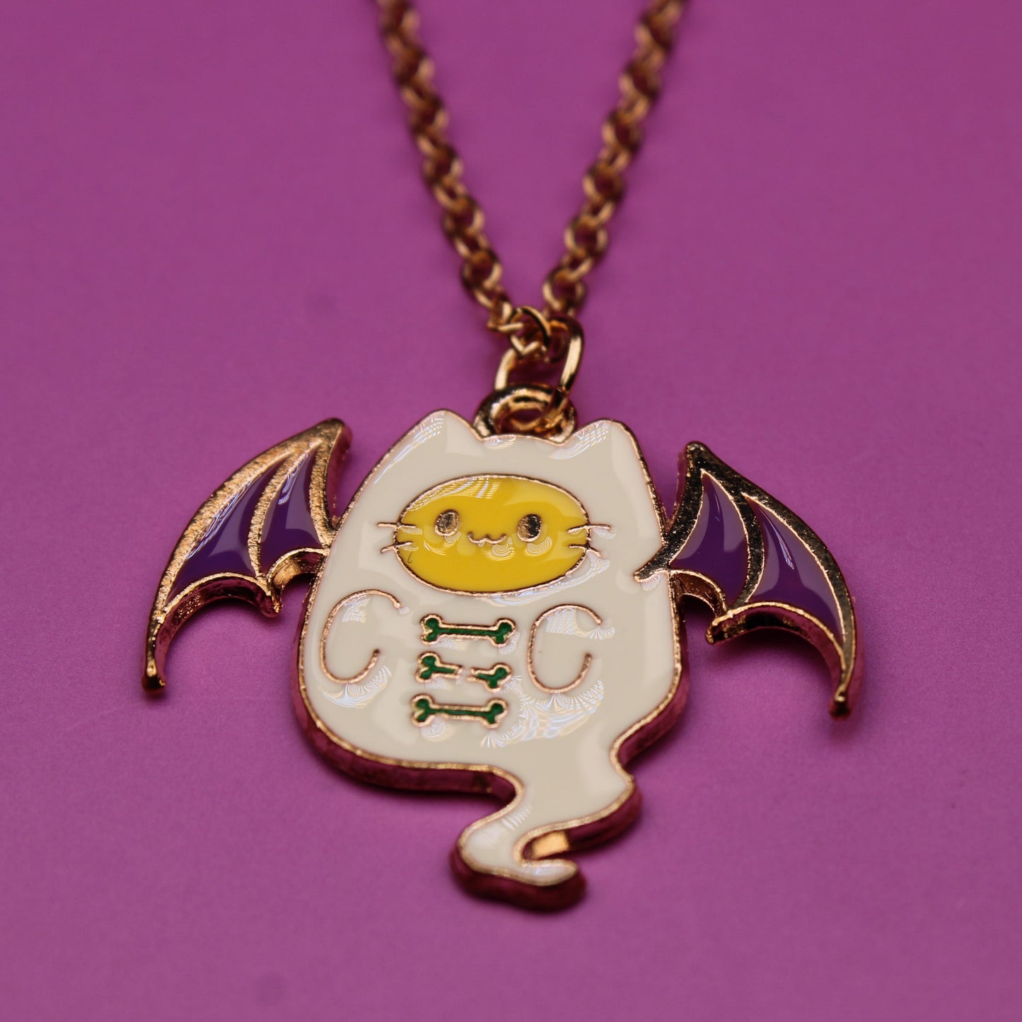 Bat-shaped pendant necklace on a purple background