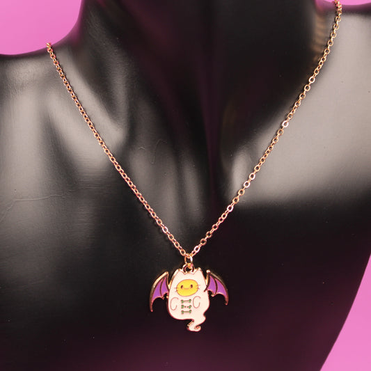 Necklace with a bat-shaped pendant on a black mannequin against a pink background