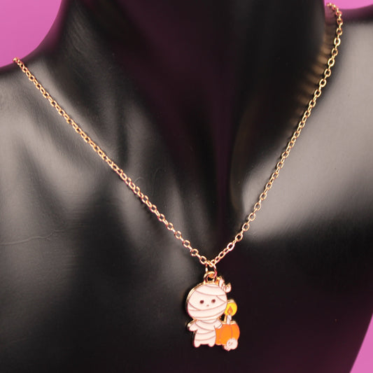 Necklace with a pendant on a black mannequin bust against a pink background